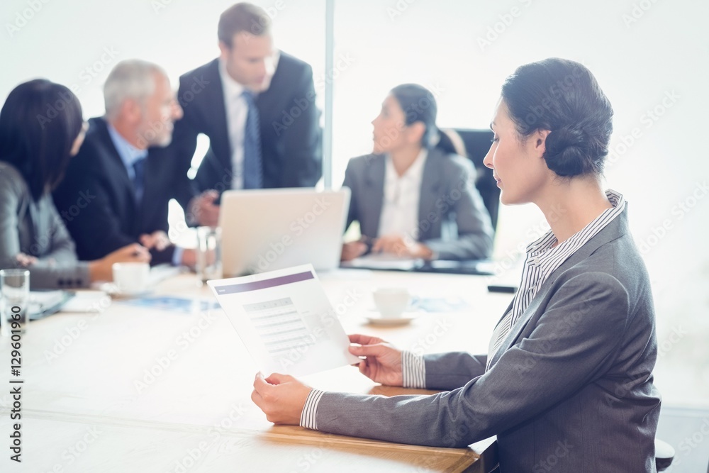 Side view of businesswoman reading report Side view of businesswoman reading report