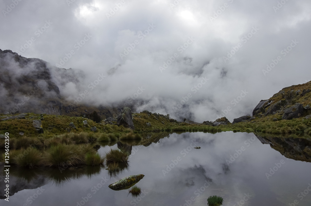 Clouds reflection in mountain lake near Punta Union pass. Huascaran National Park, Cordillera Blanca - Santa Cruz Circuit Trekking. Peru Clouds reflection in mountain lake near Punta Union pass. Huascaran National Park, Cordillera Blanca - Santa Cruz Circuit Trekking. Peru