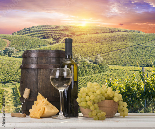Fototapeta Naklejka Na Ścianę i Meble -  Red wine with barrel on vineyard in green Tuscany, Italy