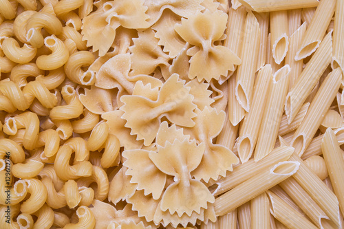 horns, feathers, bows pasta or macaroni background, texture