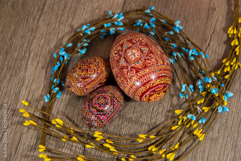 beautiful hand-painted Easter eggs for Easter, three eggs, red patterned like substrate