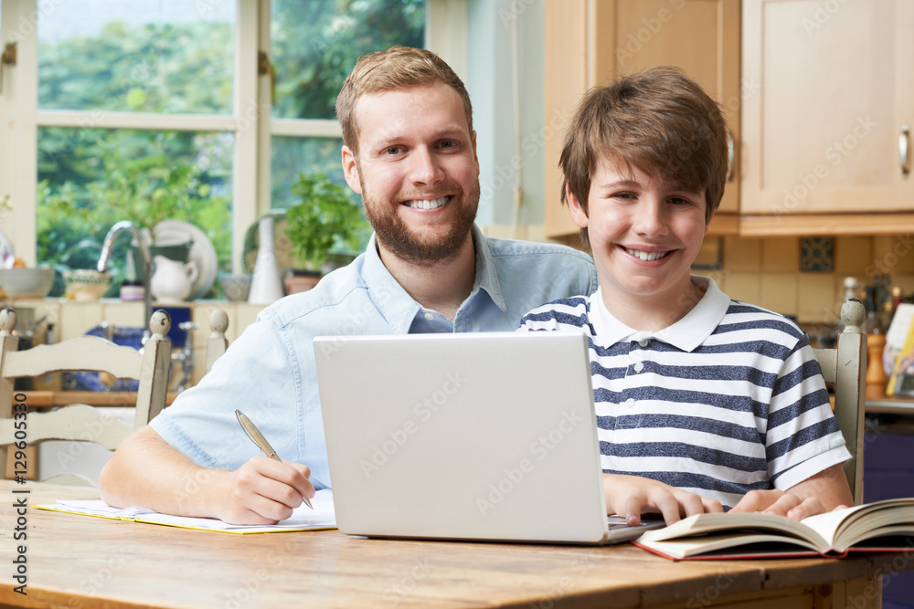 Fototapeta premium Male Home Tutor Helping Boy With Studies