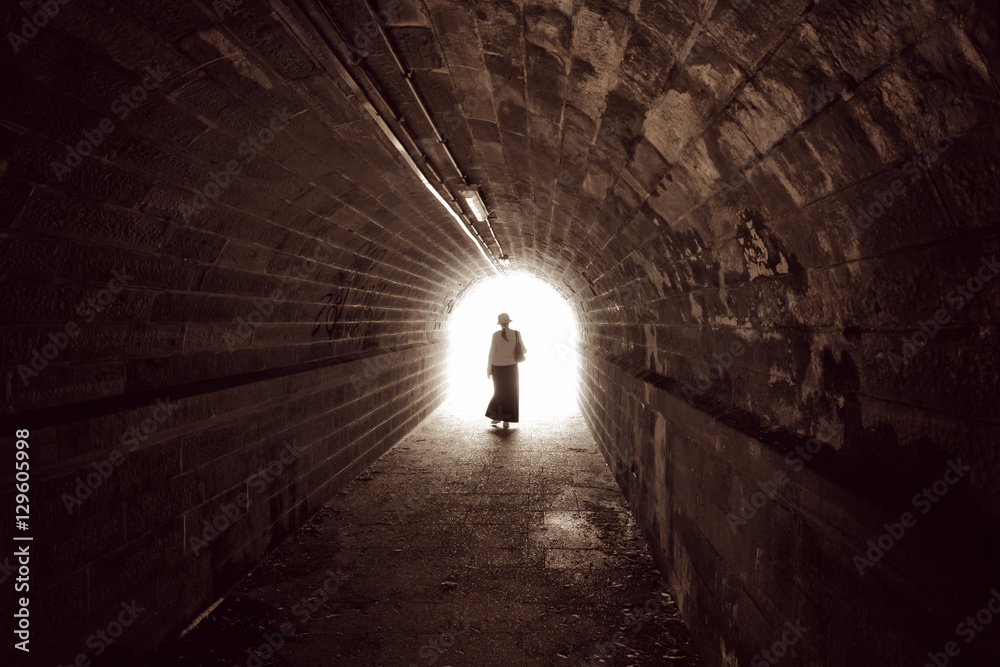 Silhouette of a woman in a tunnel