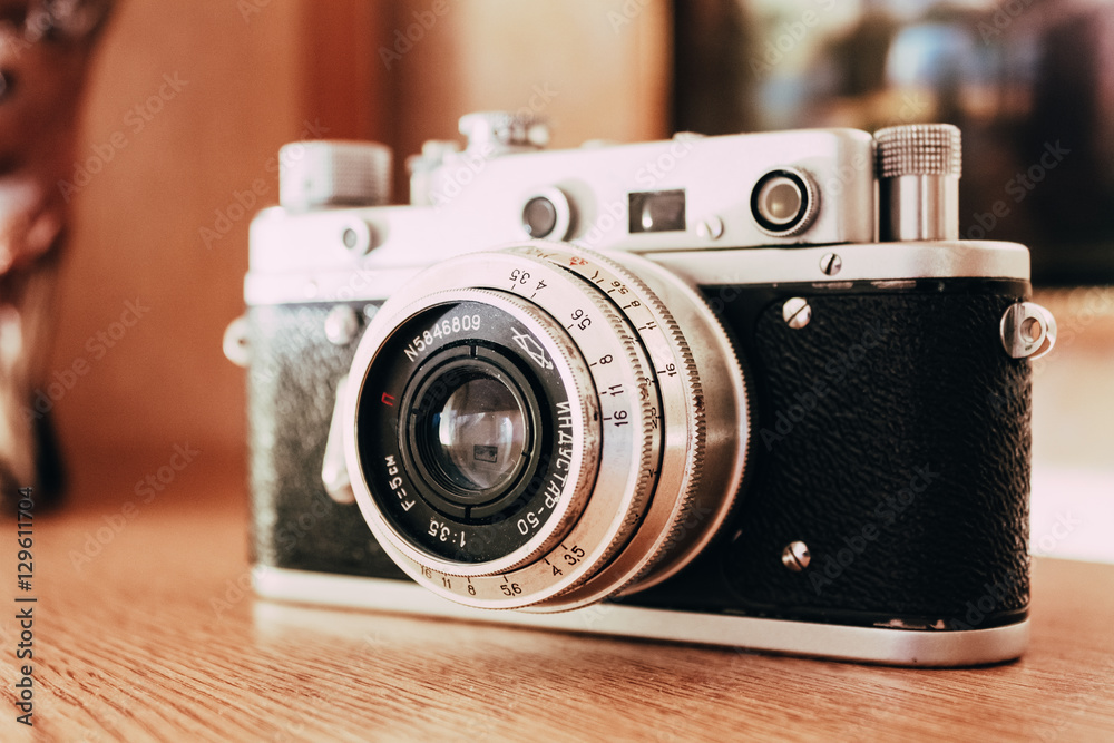 Vintage Film Camera Is On Wooden Shelf At Home