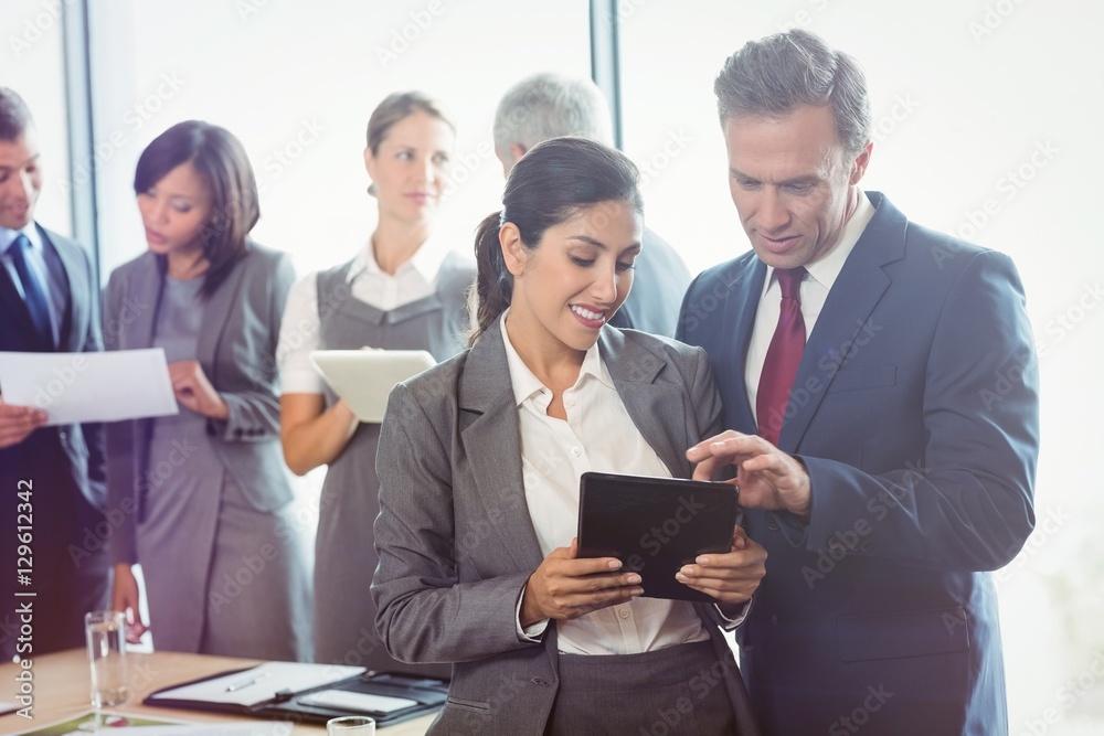 Businessman and businesswoman using digital tablet Businessman and businesswoman using digital tablet