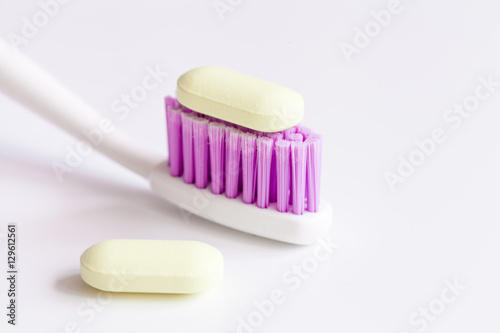 concept toothache with toothbrush and pills at white background