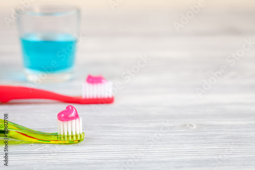 children s toothbrush oral care on wooden background