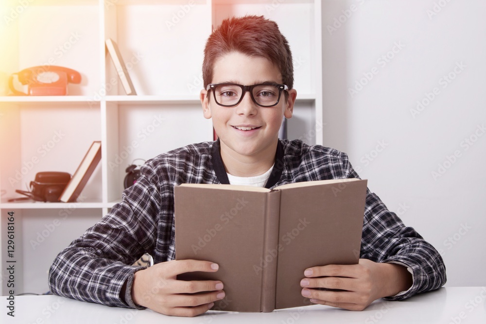 child at home with the book studying or reading child at home with the book studying or reading