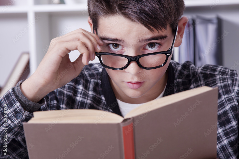 child at home with the book studying or reading child at home with the book studying or reading