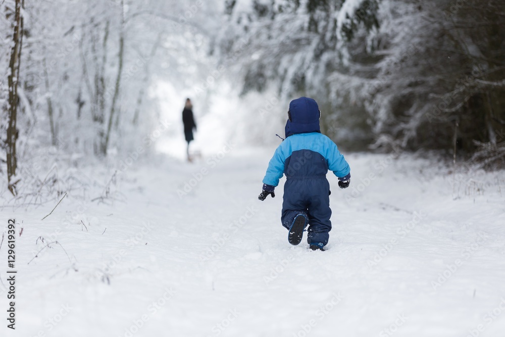 Happy caucasian child playing in snow