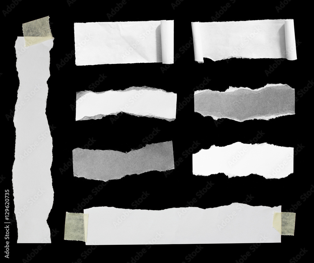 Pieces of torn paper on black. Copy space
