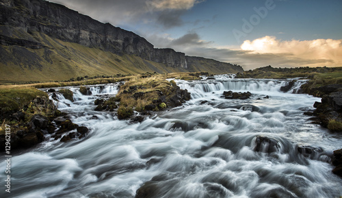 stunning river flow beside the road along iceland