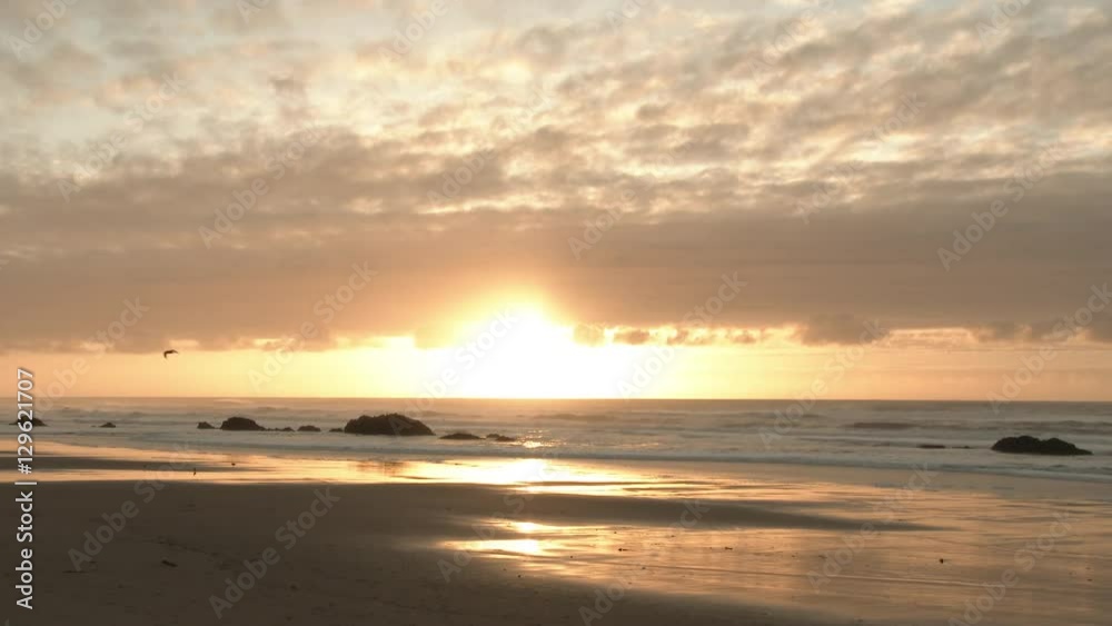 Real time scenic at the Oregon Coast during sunset with the sun shining bright and colorful clouds filling the sky. Real time scenic at the Oregon Coast during sunset with the sun shining bright and colorful clouds filling the sky.
