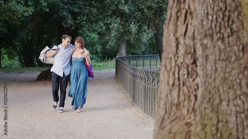 portrait of couple in love walking in the park after shopping portrait of couple in love walking in the park after shopping