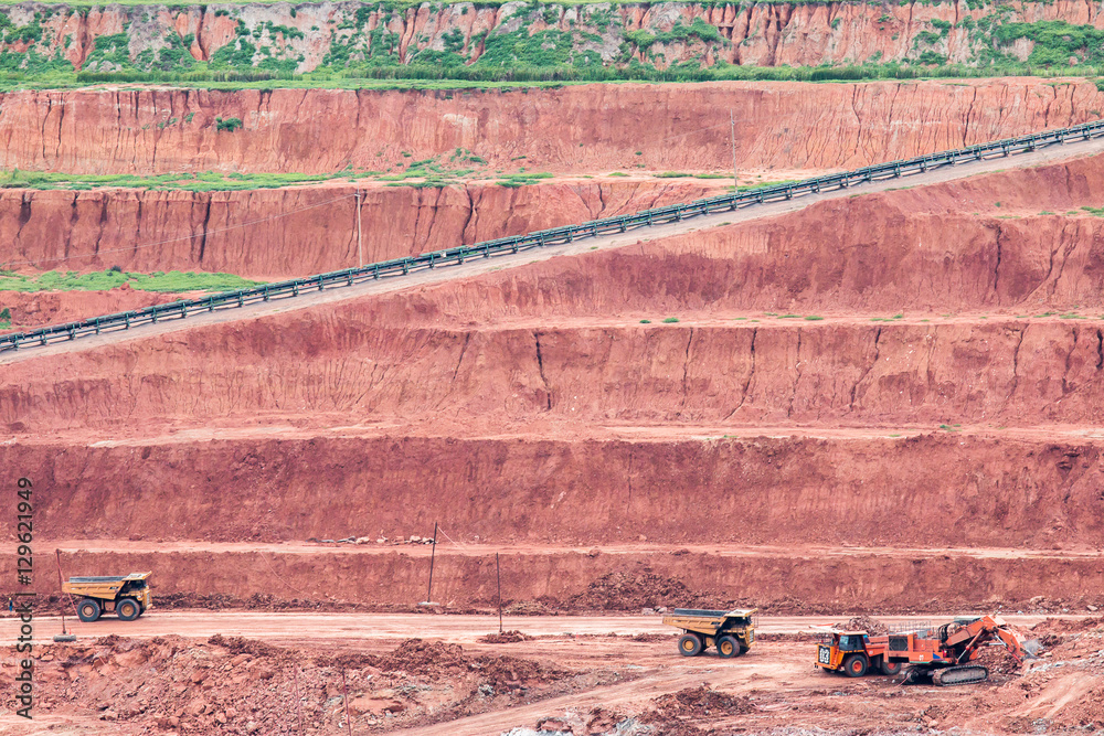 Obraz premium Part of a pit with big mining truck working