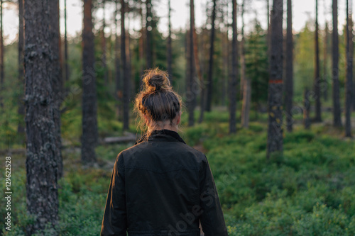 Bilde på lerret woman walking in green forest