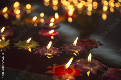 Flower candles floating on water.
