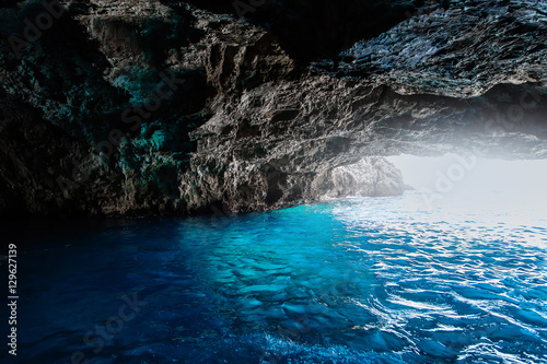 Sea cave with blue water at daytime