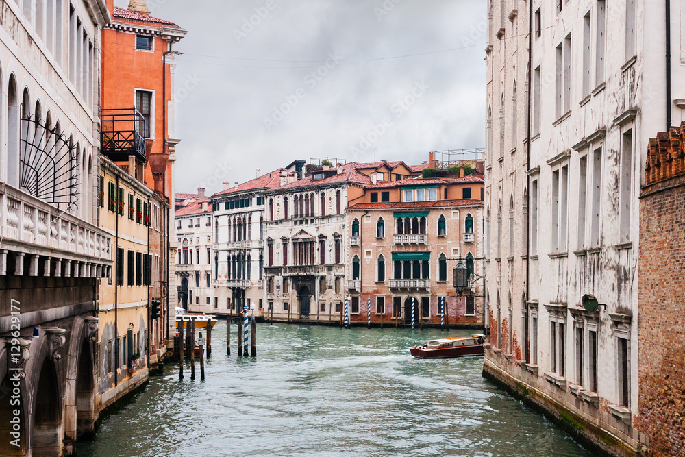 canal and old buildings in Venice city in rain