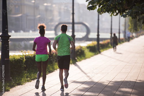 young multiethnic couple jogging in the city