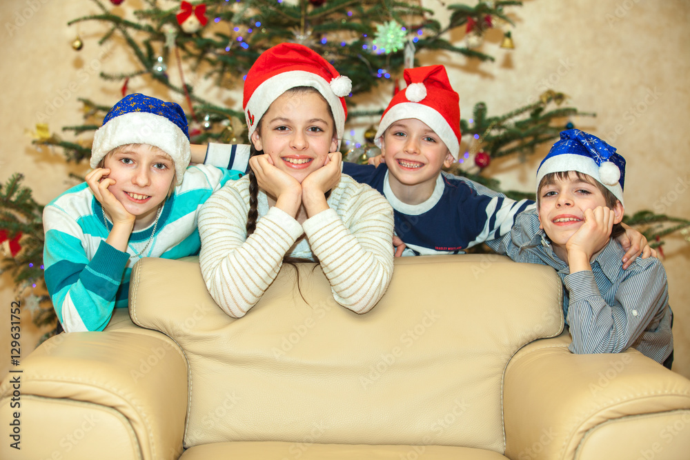 Happy group of children near a Christmas tree Happy group of children near a Christmas tree