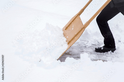 Man cleaning snow with big shovel in winter day. © fotoduets