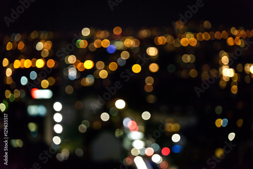 Blurred background of city lights. Bokeh with different colored lights. © Petar Bonev
