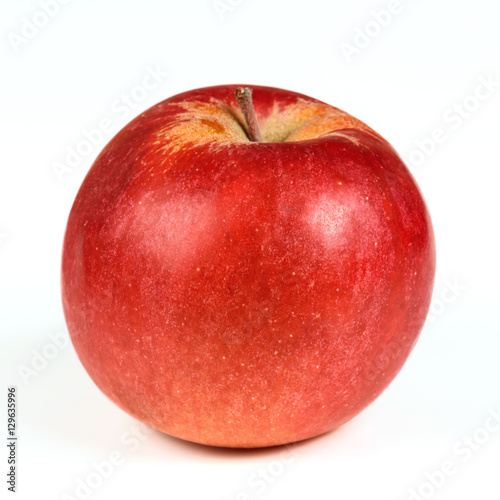 One red ripe apple close up on a white background.