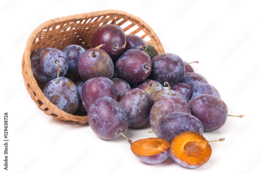 Fototapeta premium plum in a wicker basket isolated on white background