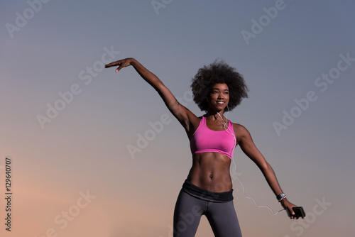 black woman is doing stretching exercise relaxing and warm up