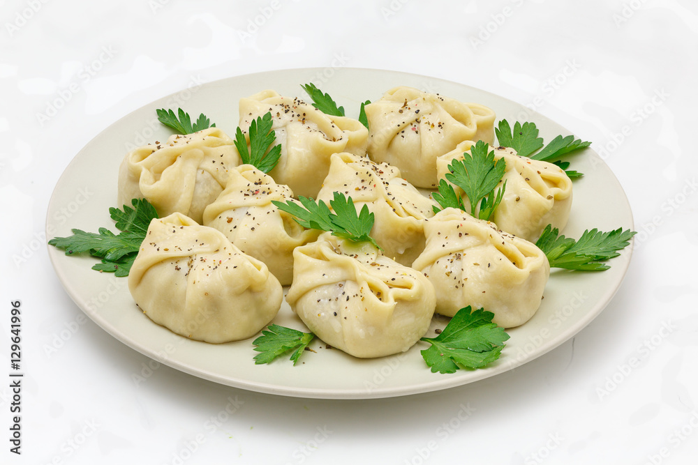 manty with meat on a white plate, isolated