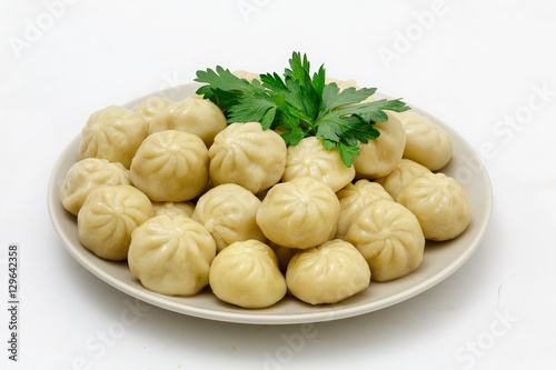 Meat dumplings - russian pelmeni, ravioli with meat on a plate, isolated