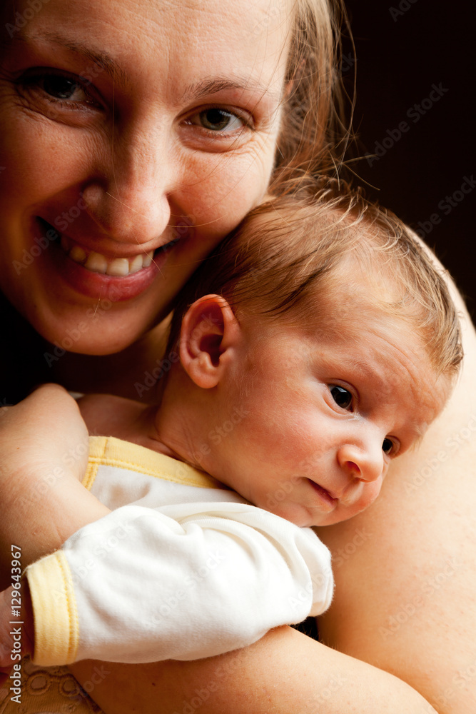 Young mother holding her baby boy and smiling at the camera. Iso Young mother holding her baby boy and smiling at the camera. Iso