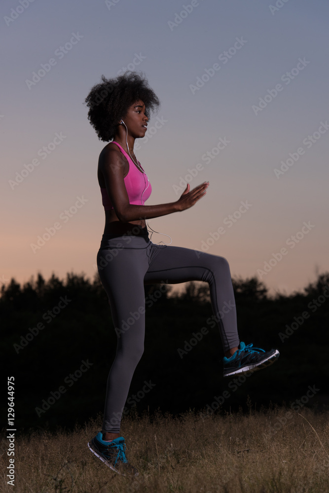 black woman is doing stretching exercise relaxing and warm up