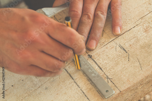 Carpenter working on raw wood.