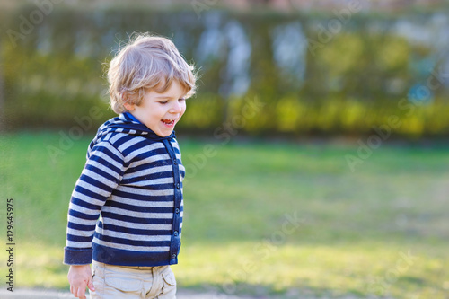 Portrait of toddler boy having fun on outdoor playground © Irina Schmidt