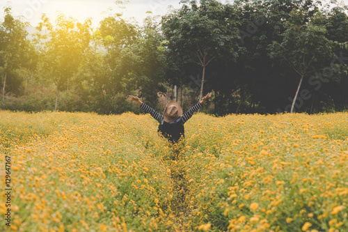 woman raise her hand up in yellow Chrysanthemum flower field, fe