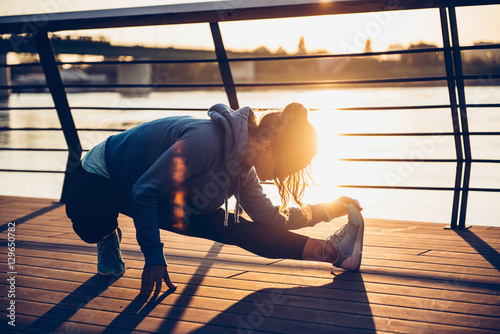 Woman streching by the river photo