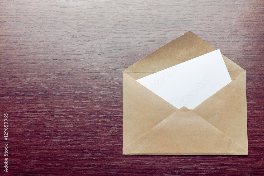 Photo of blank envelope on a  wooden background