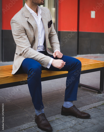 Male model sitting on  a bench