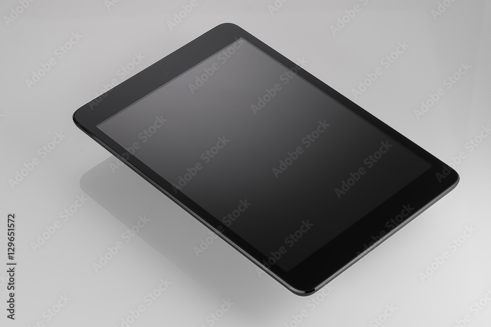 Black tablet on a white background light closeup Black tablet on a white background light closeup