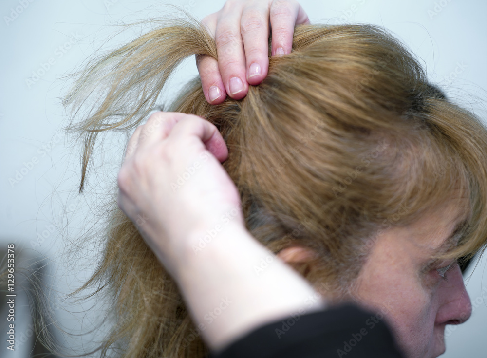 Obraz premium Woman Arranging Hair