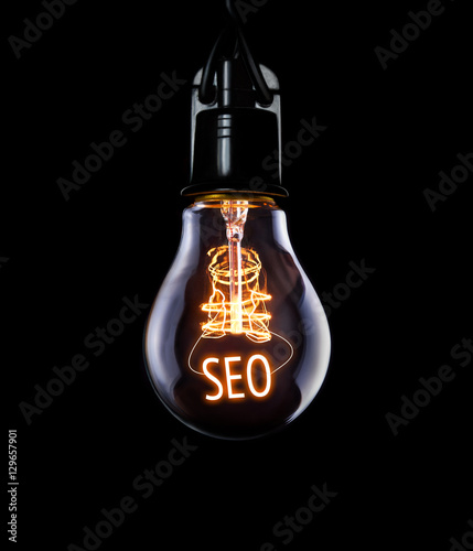 Obraz na płótnie Hanging lightbulb with glowing SEO concept. w salonie