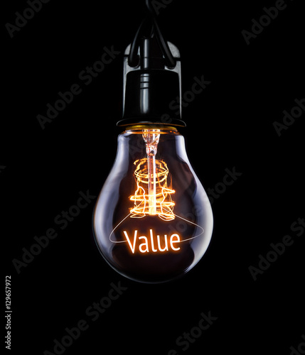 Hanging lightbulb with glowing Value concept. photo