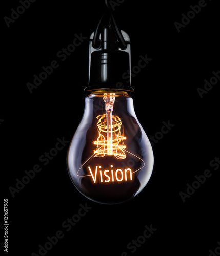 Hanging lightbulb with glowing Vision concept. photo