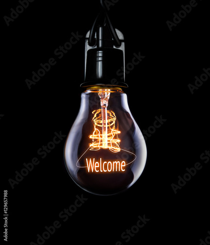 Obraz na płótnie Hanging lightbulb with glowing Welcome concept. w salonie