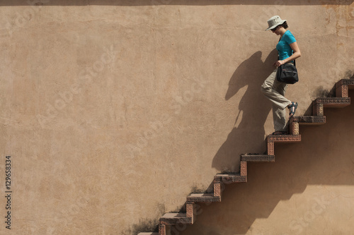 A tourist climbs downs some exposed steps within the Fatehpur Sikri temple complex, Uttar Pradesh