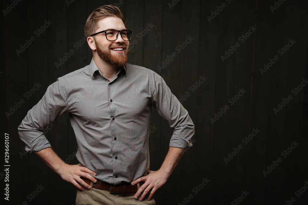 Man in eyeglasses standing with hands on hips Man in eyeglasses standing with hands on hips