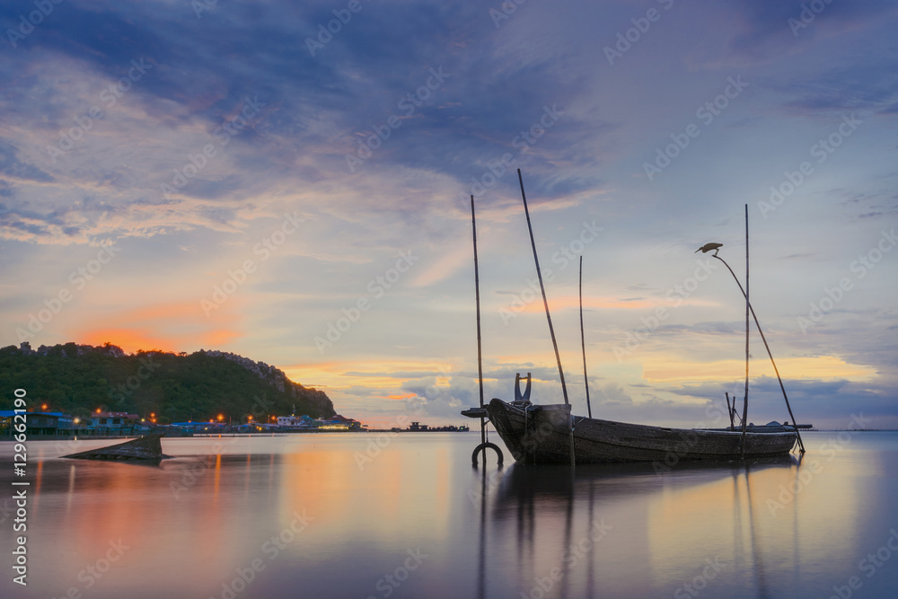 Long exposure sunset shot near old fishermen boat