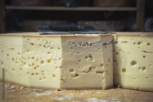 Whole emmental cheese ready to be sliced - Swiss cheese - French emmental cheese